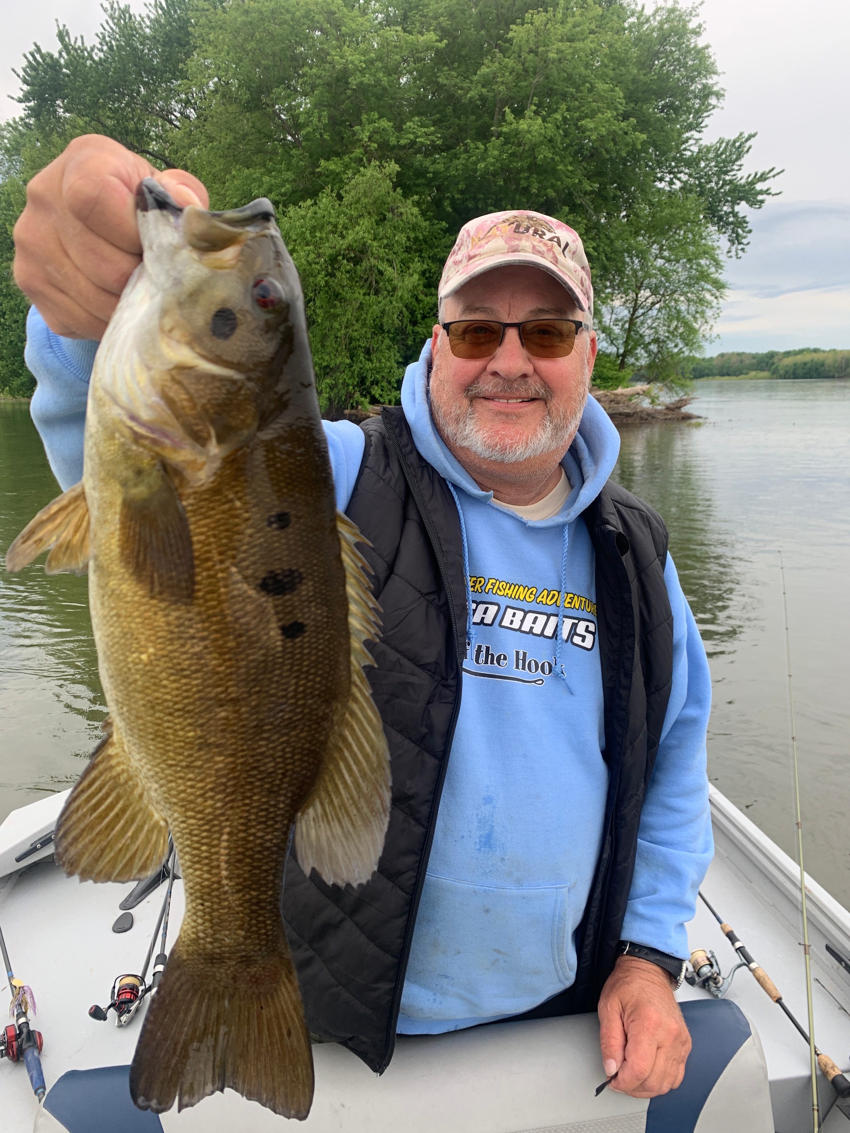Client with a large smallmouth bass on a sunny day