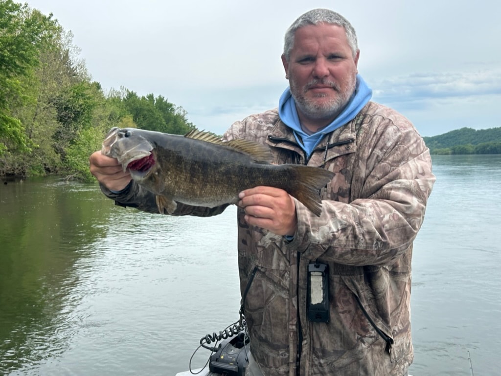 Angler holding trophy smallmouth bass on the Upper Potomac River